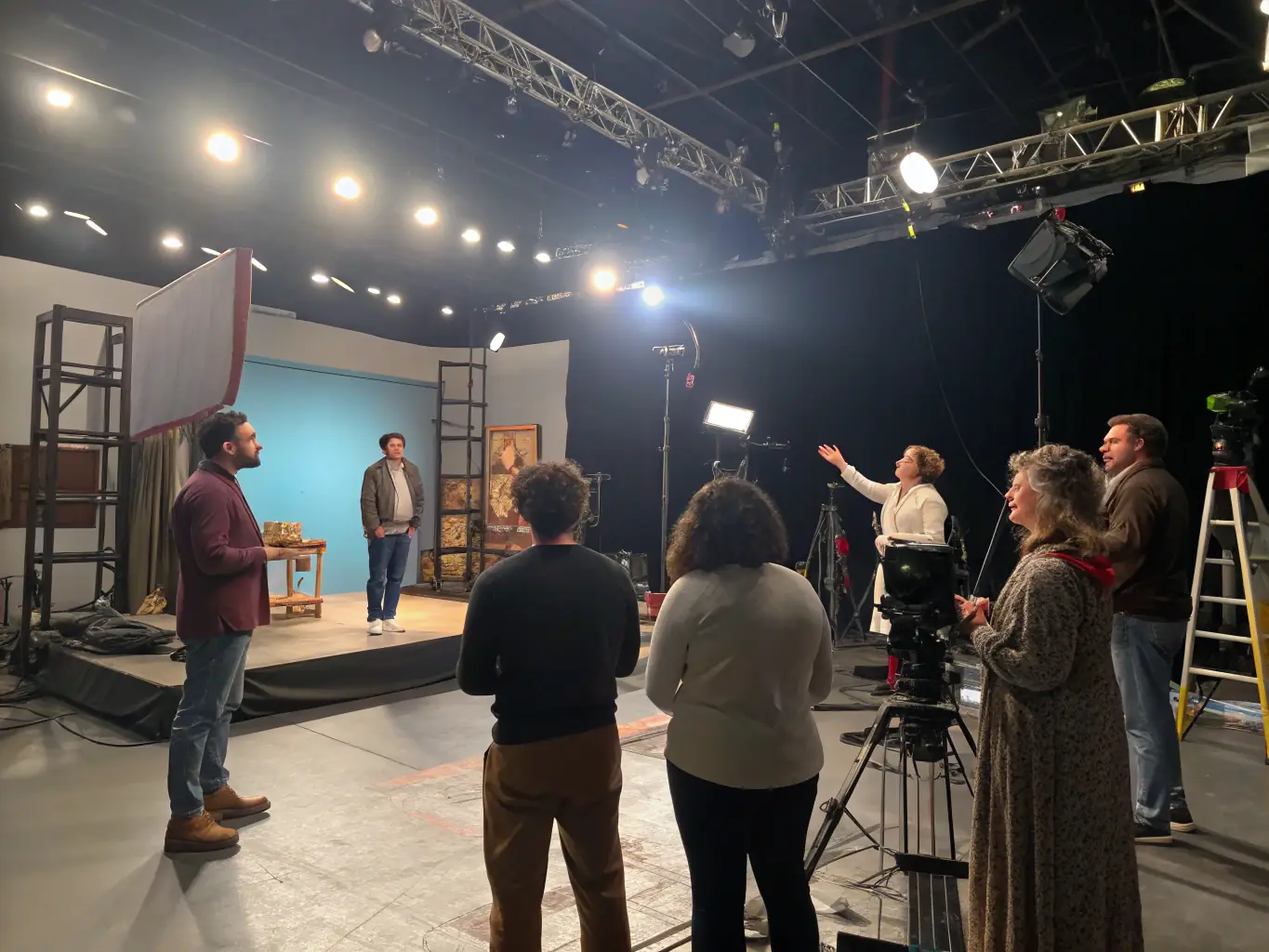 A dynamic image capturing a performance arts training session, featuring actors rehearsing on stage, highlighting the energy and collaborative spirit of the program.